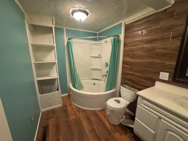 a bathroom with a toilet and a shower