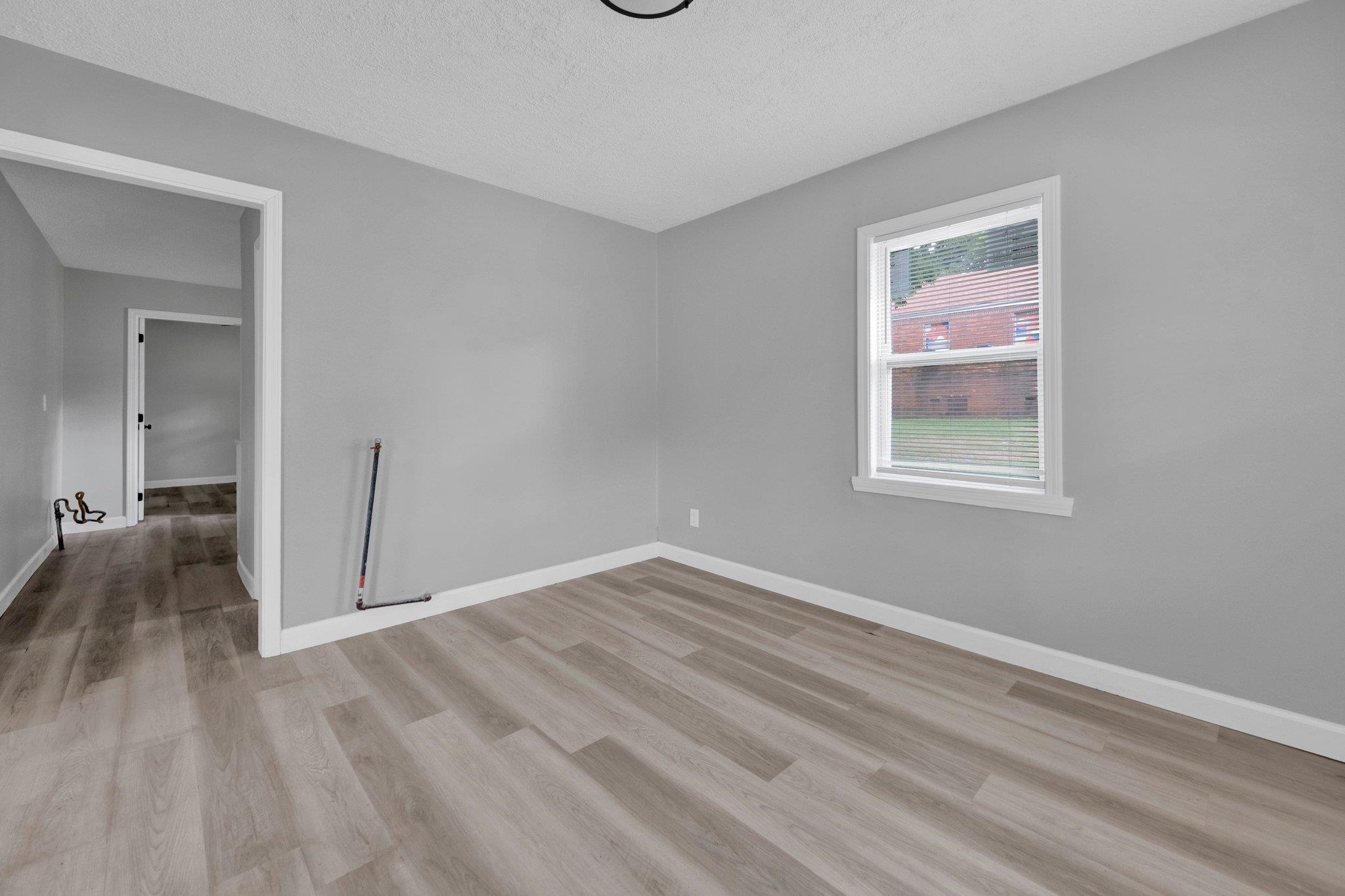 160 Silverage Avenue Memphis, TN 38109 - Photo 5 of 11 Spare room with light wood-type flooring and a textured ceiling