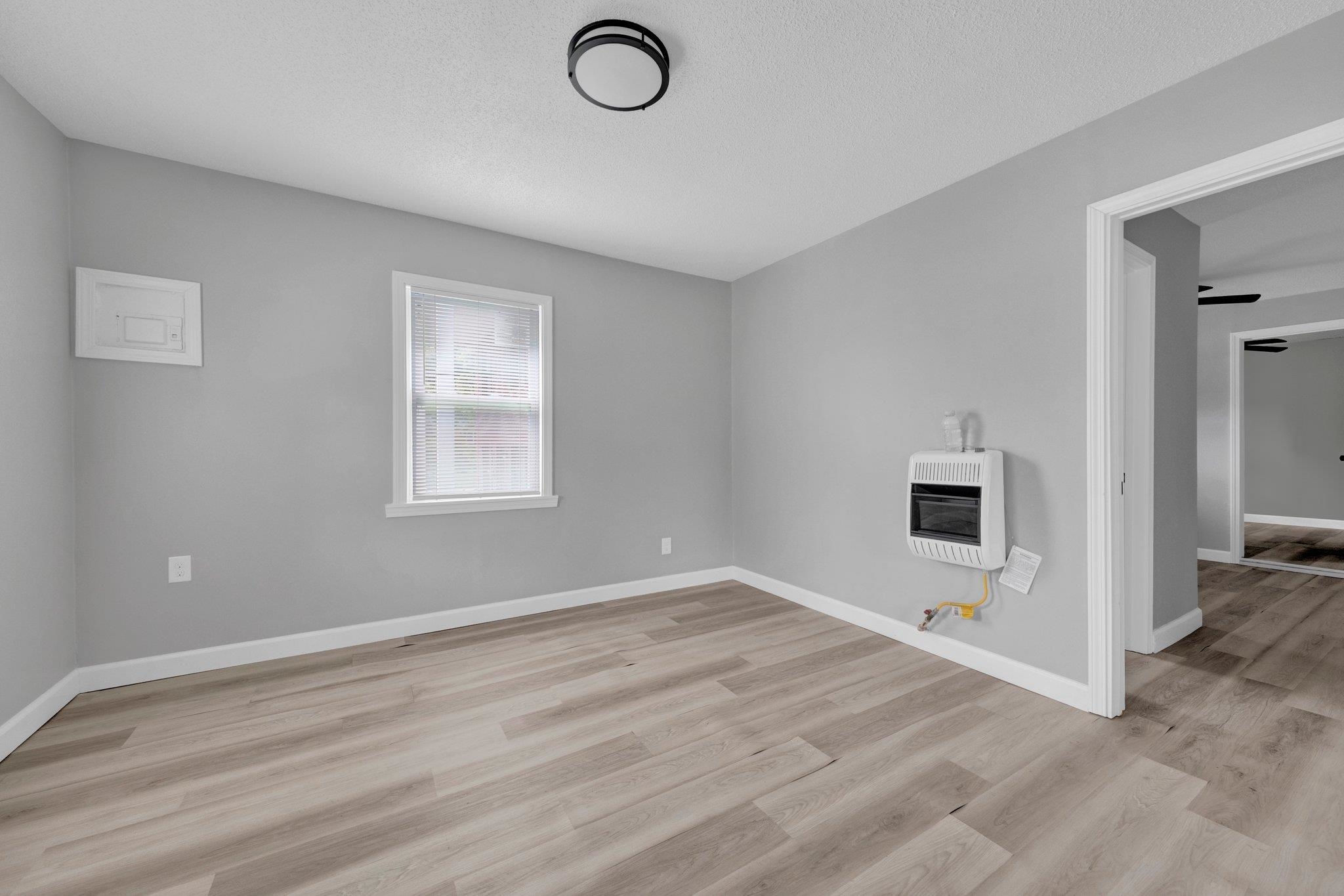 160 Silverage Avenue Memphis, TN 38109 - Photo 7 of 11 Spare room with light wood-style flooring, a textured ceiling, and heating unit