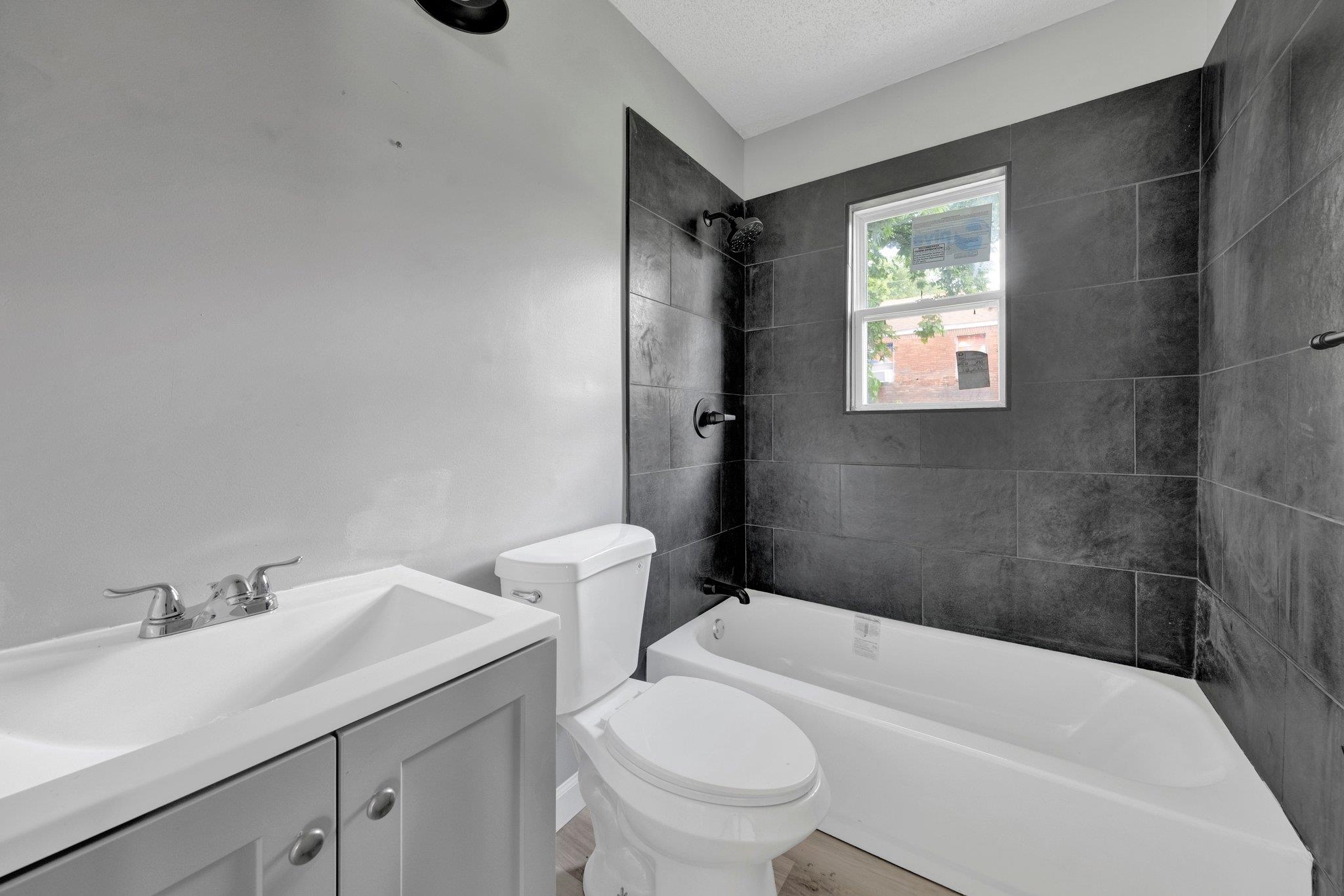 160 Silverage Avenue Memphis, TN 38109 - Photo 8 of 11 Bathroom with shower / bath combination, vanity, a textured ceiling, and light wood-style floors