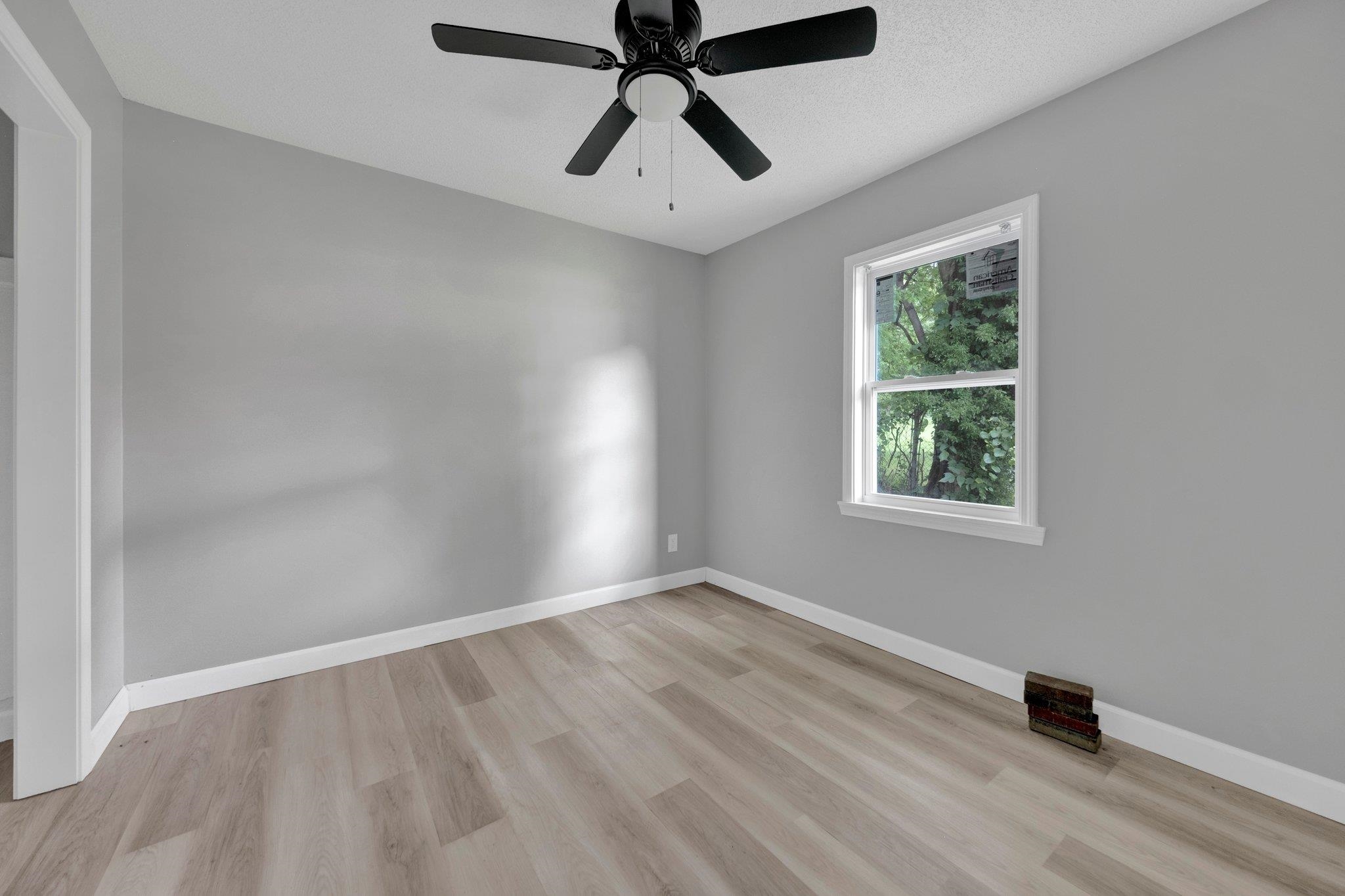 160 Silverage Avenue Memphis, TN 38109 - Photo 9 of 11 Unfurnished room with light wood-style flooring, ceiling fan, and a textured ceiling