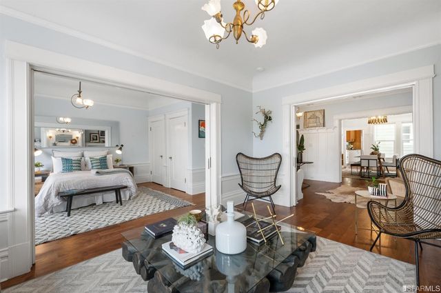a living room with furniture a fireplace and a chandelier