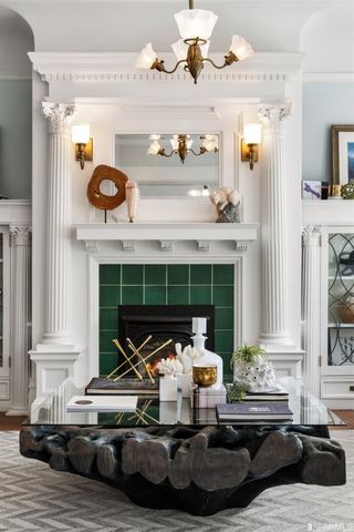a living room with fireplace furniture and a floor to ceiling window