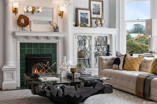 a living room with furniture and a floor to ceiling window