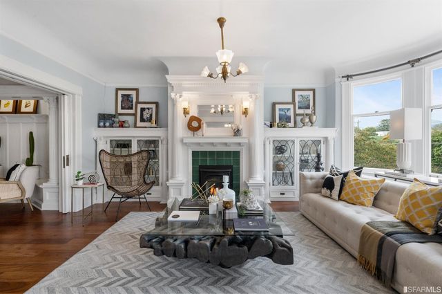 a living room with furniture large window and a fireplace
