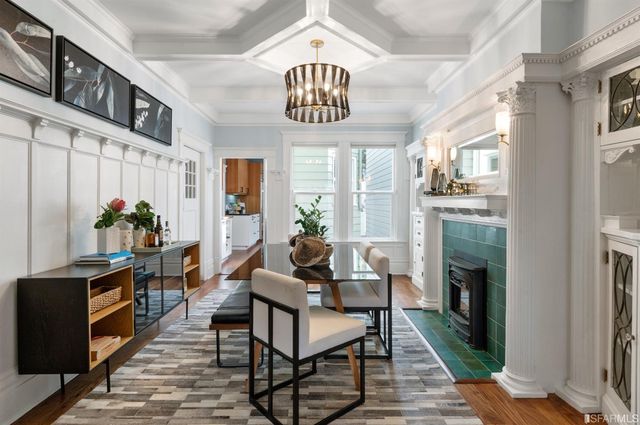 a kitchen with stainless steel appliances a sink cabinets and wooden floor