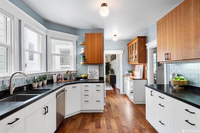 a bedroom with furniture and a large window