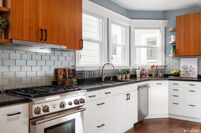 a bedroom with furniture and a large window