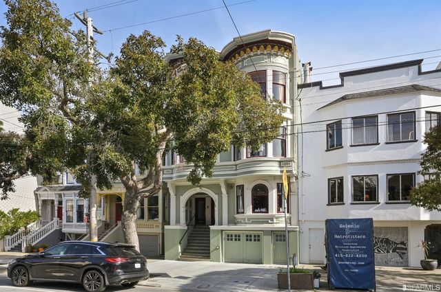 a front view of a residential apartment building with a yard