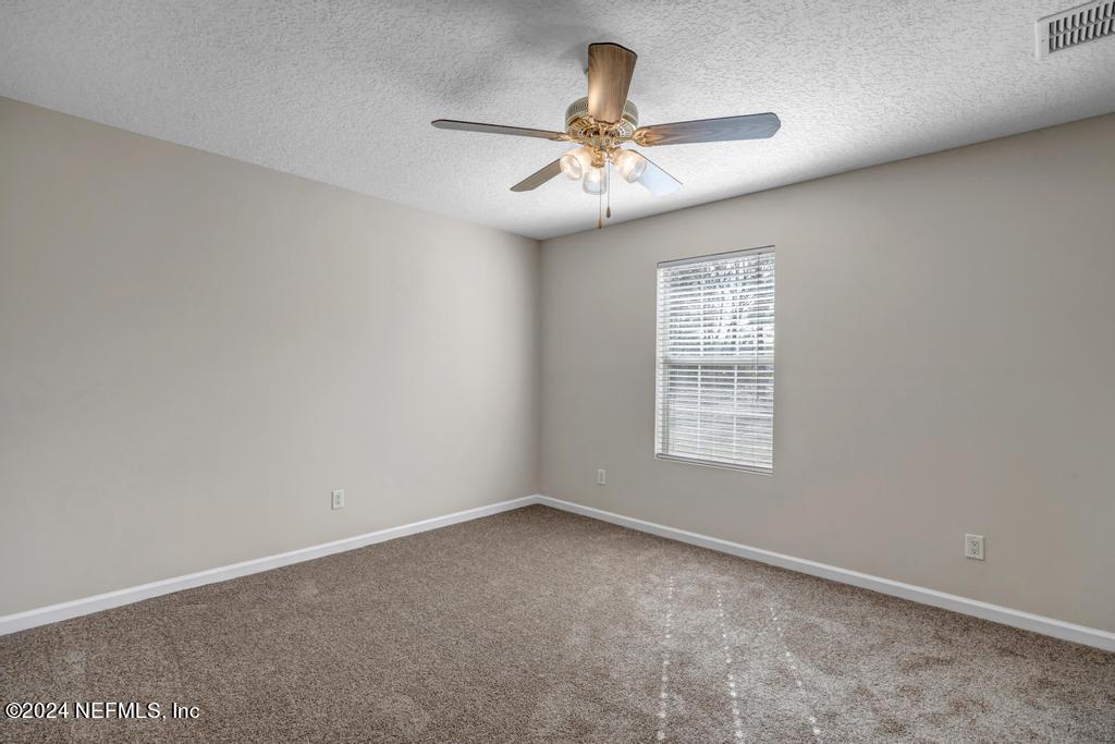 3308 Thunder Road Middleburg, FL 32068 - Photo 20 of 39 an empty room with a window and a fan