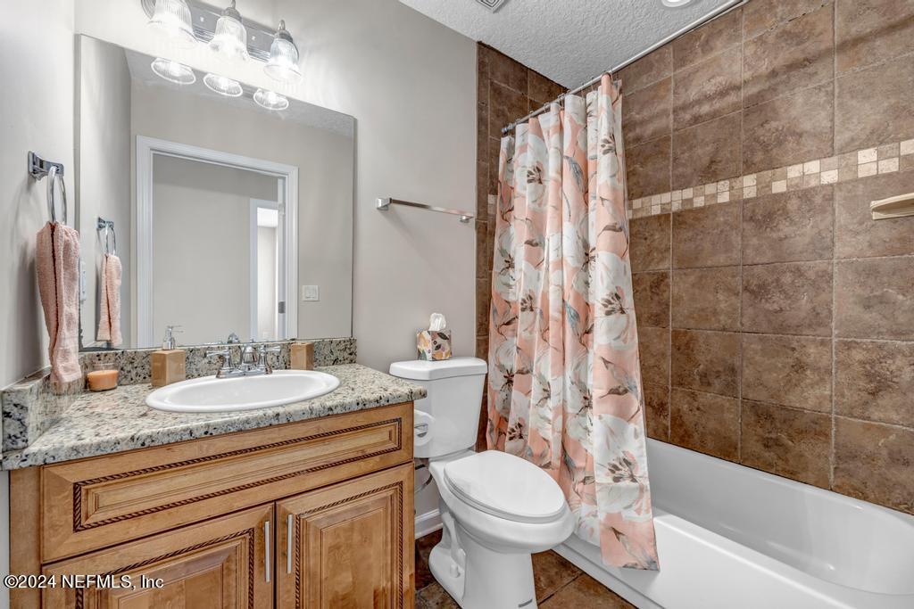 3308 Thunder Road Middleburg, FL 32068 - Photo 24 of 39 a bathroom with a granite countertop sink mirror vanity and toilet