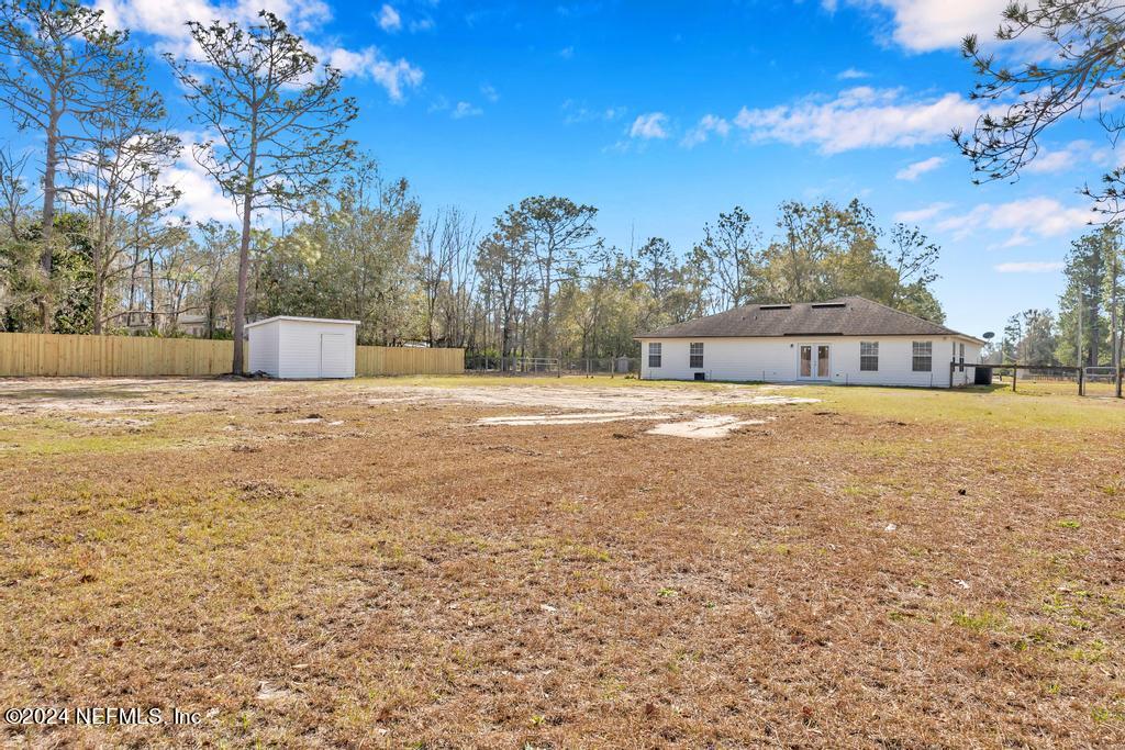 3308 Thunder Road Middleburg, FL 32068 - Photo 28 of 39 a view of a house with a big yard and large trees