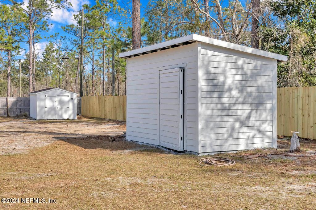 3308 Thunder Road Middleburg, FL 32068 - Photo 32 of 39 a wooden house with trees in front of it