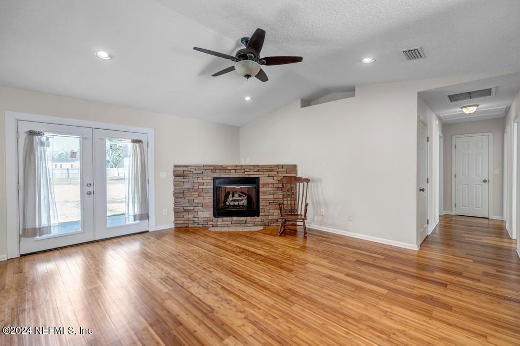 3308 Thunder Road Middleburg, FL 32068 - Photo 5 of 39 a view of an empty room with wooden floor fireplace and a window