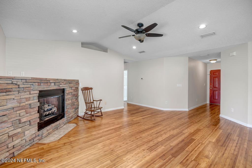 3308 Thunder Road Middleburg, FL 32068 - Photo 7 of 39 a view of a livingroom with a fireplace and a workspace