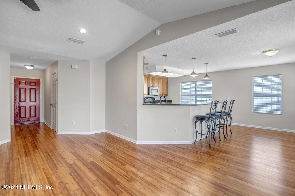 3308 Thunder Road Middleburg, FL 32068 - Photo 8 of 39 a view of a kitchen with furniture and wooden floor