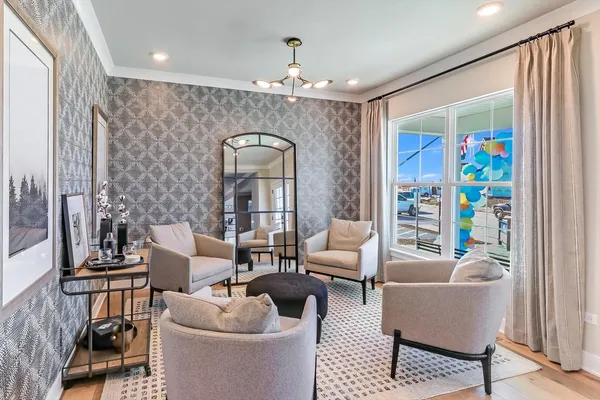 a living room with furniture and a chandelier