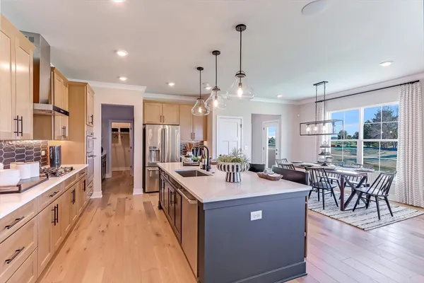 a large kitchen with lots of counter space and dining table