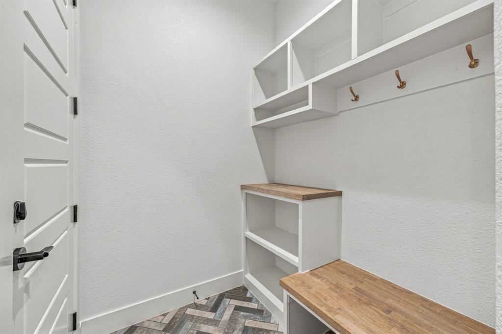8140 Lavender Road Springtown, TX 76082 - Photo 17 of 40 Built-in white cabinetry with wood-finish countertops and shelving