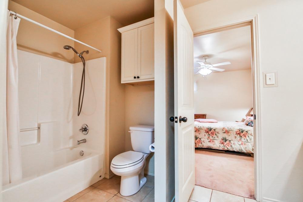 3118 113th Street Lubbock, TX 79423 - Photo 11 of 24 a bathroom with a toilet sink and shower
