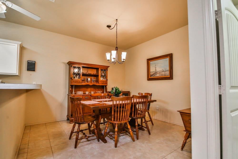 3118 113th Street Lubbock, TX 79423 - Photo 14 of 24 a view of a dining room with furniture and chandelier