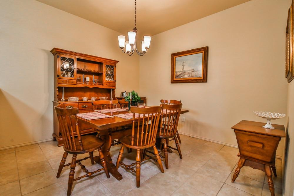3118 113th Street Lubbock, TX 79423 - Photo 15 of 24 a view of a dining room with furniture and chandelier
