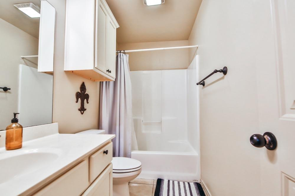 3118 113th Street Lubbock, TX 79423 - Photo 17 of 24 a bathroom with a sink toilet and shower