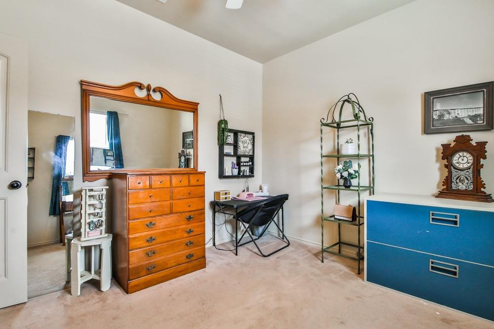 3118 113th Street Lubbock, TX 79423 - Photo 19 of 24 a view of a workspace with furniture and a dresser