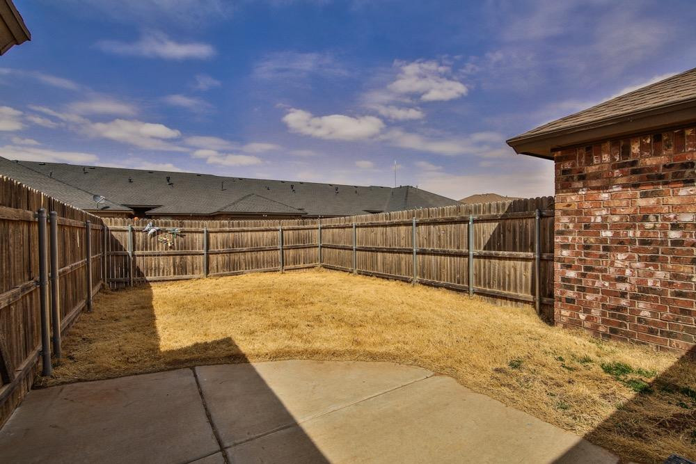 3118 113th Street Lubbock, TX 79423 - Photo 22 of 24 a view of swimming pool with a yard
