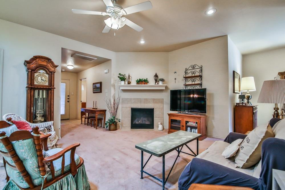 3118 113th Street Lubbock, TX 79423 - Photo 5 of 24 a living room with furniture and a fireplace