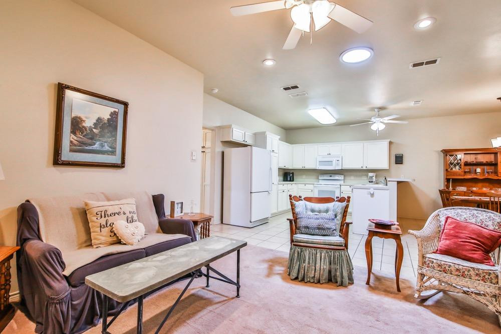 3118 113th Street Lubbock, TX 79423 - Photo 6 of 24 a living room with furniture and kitchen view