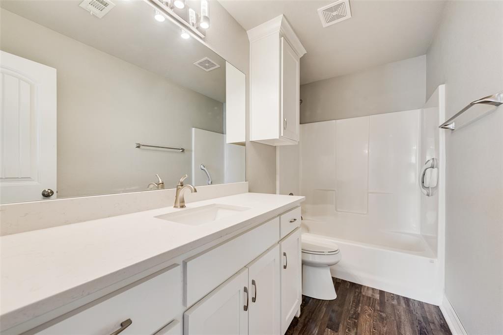 625 Copenhavr Street Pilot Point, TX 76258 - Photo 11 of 20 Bathroom featuring vanity, dark wood-style flooring, and shower / bath combination