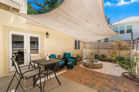 a backyard of a house with table and chairs