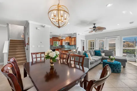 a kitchen with granite countertop a table chairs microwave and cabinets