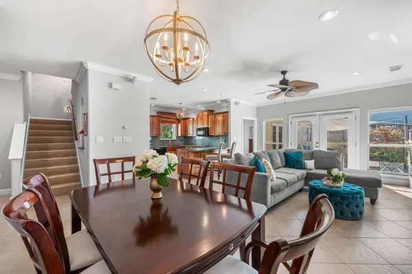 a kitchen with granite countertop a table chairs microwave and cabinets