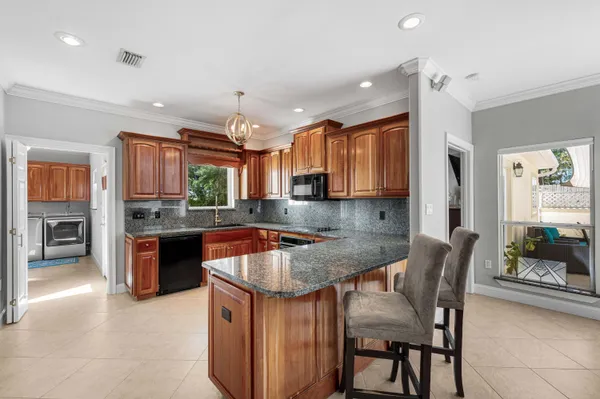 a kitchen with stainless steel appliances granite countertop a sink stove and microwave