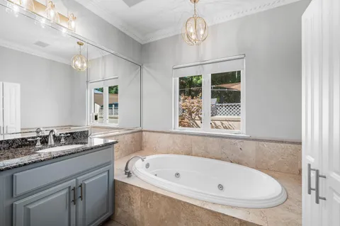 a white bath tub sitting next to a bathroom sink