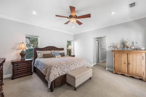 a bedroom with a large bed and a flat screen tv