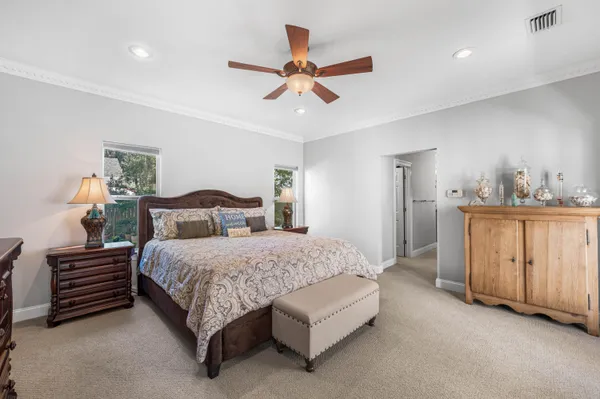 a bedroom with a large bed and a flat screen tv