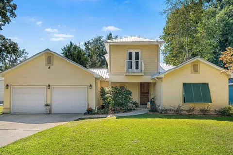 a view of a house with a yard and garage