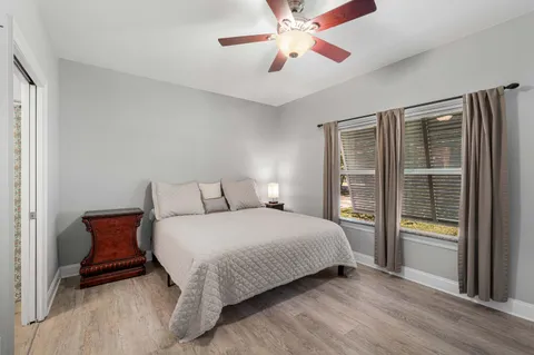 a bathroom with a granite countertop sink a toilet and shower curtain