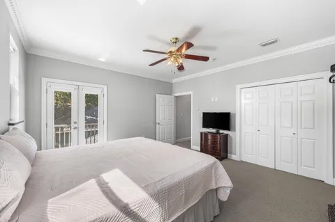 a bedroom with a bed and a large window