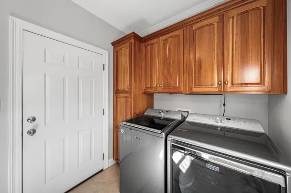 a spacious bedroom with a bed and a flat tv screen on the dresser