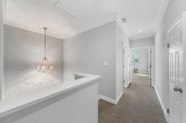 a bedroom with a large bed a flat tv screen and dresser