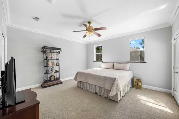 a bedroom with a bed and a large window