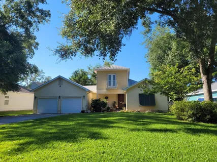 a front view of house with yard and green space