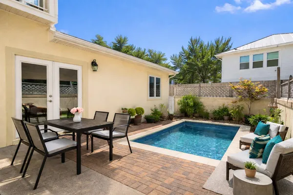a backyard of a house with table and chairs