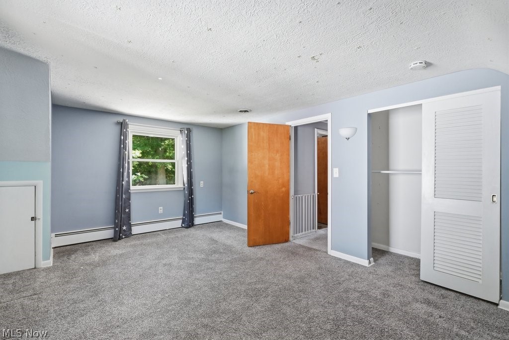 136 Pinehurst Road Munroe Falls, OH 44262 - Photo 28 of 48 Spacious room featuring light blue walls, gray carpet, and a large window with natural light
