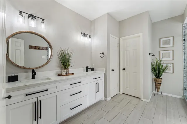 a bathroom with a double vanity sink and a mirror