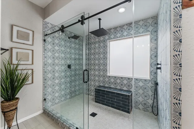 a bathroom with a shower and a mirror